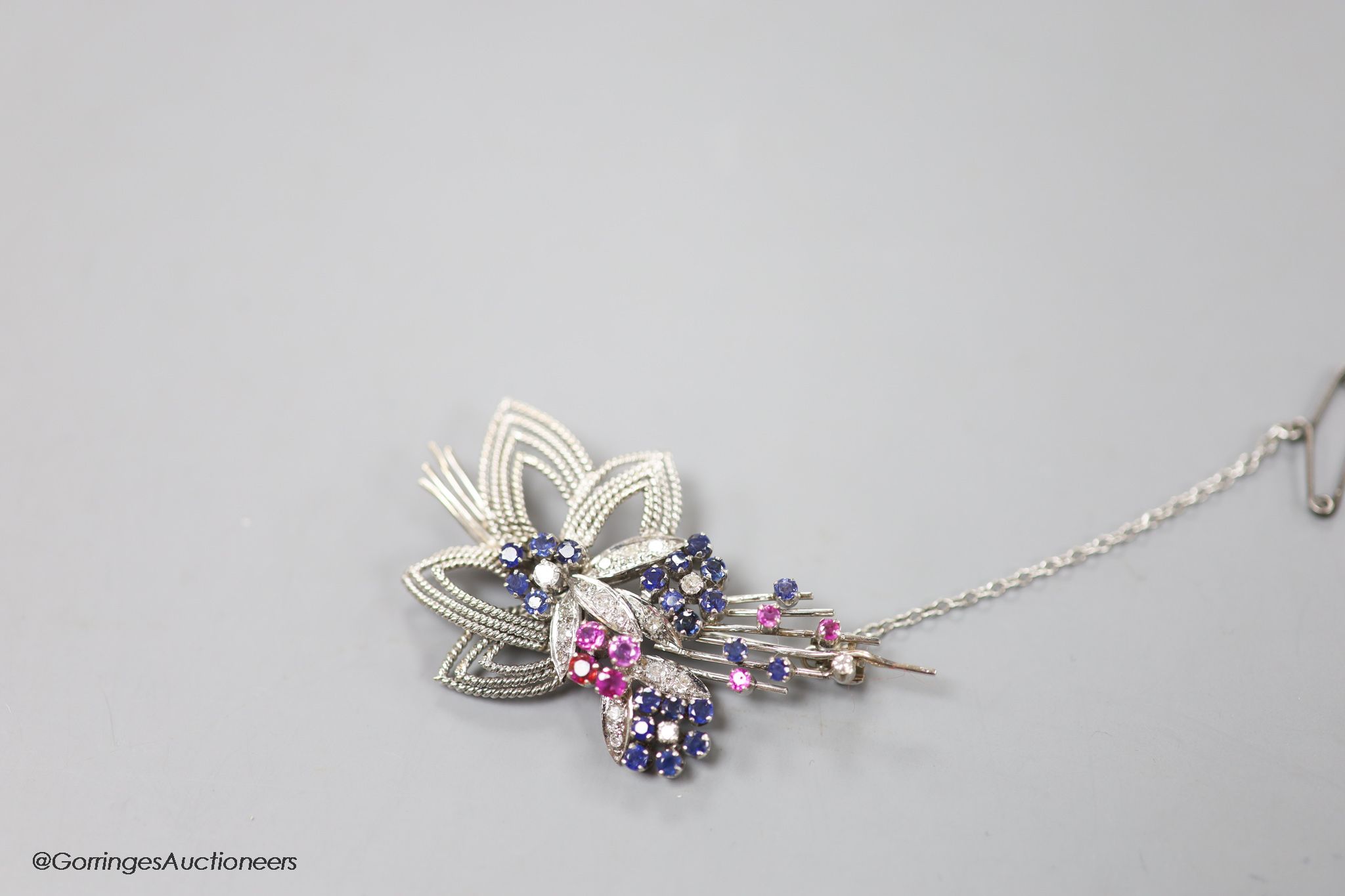 A modern white metal, ruby, sapphire and diamond set foliate spray brooch, 567mm